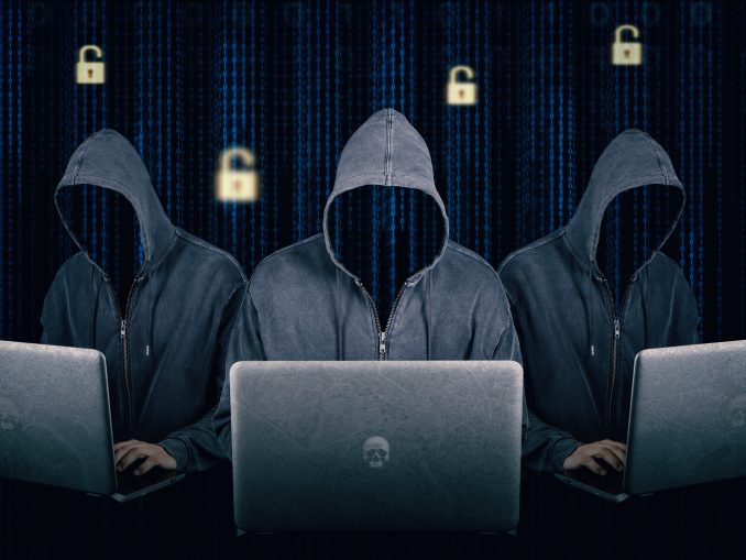 Dangerous hooded group of hackers. Internet, cyber crime, cyber attack, system breaking and malware concept. Dark face. Anonymous. Digital binary code on background.