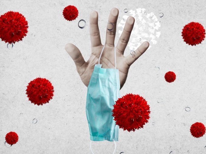 hand_holding_face_mask_surrounded_by_virus_morphology_covid-19_coronavirus_pandemic_by_rawpixel_wan_id_2317454_cc0_2400x1600-100839292-orig